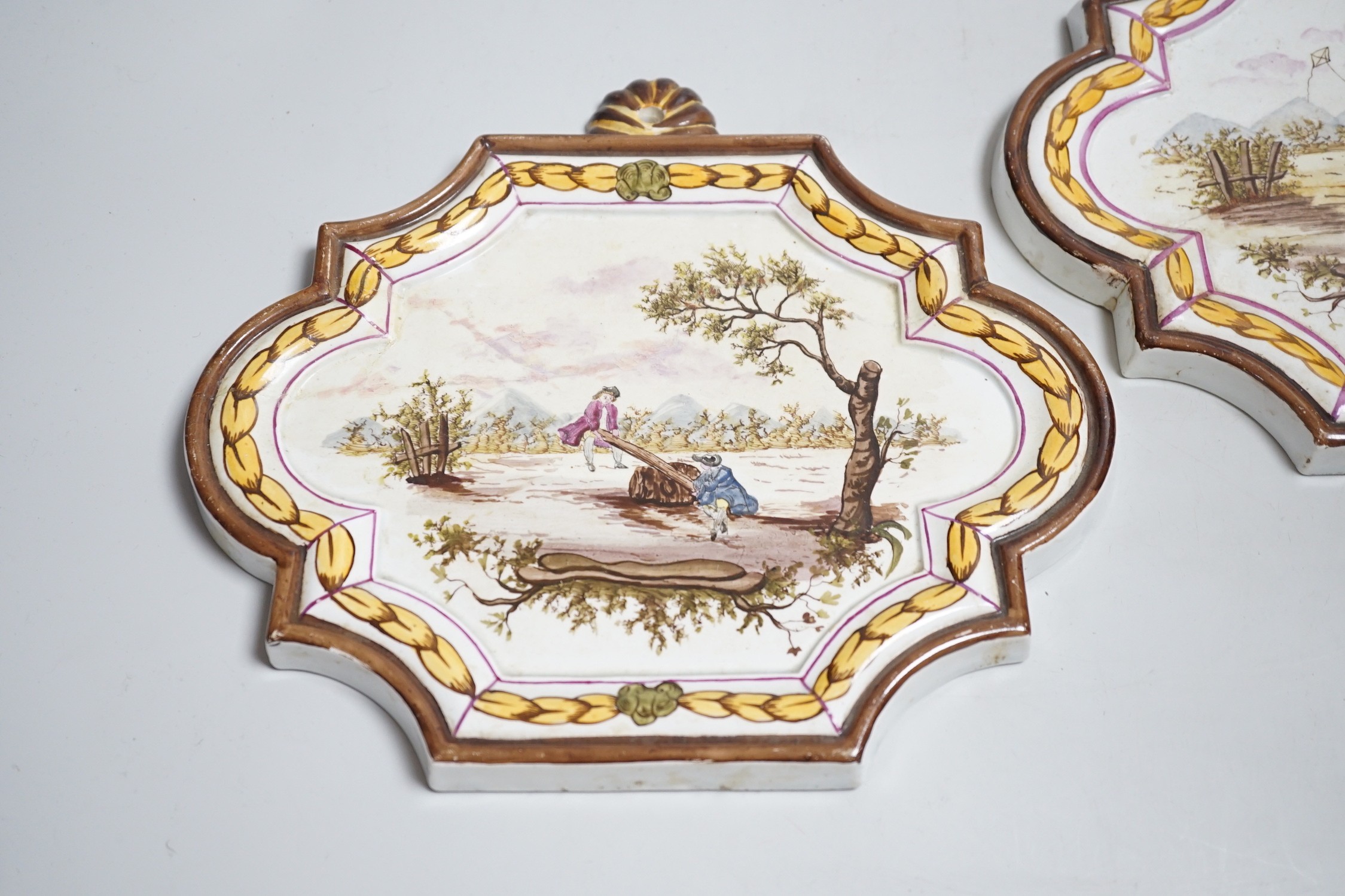 A pair of 19th century painted faience plaques in the style of Veuve Perrin 23cm